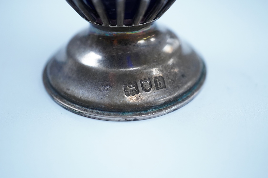 An Edwardian pierced silver sugar caster, with blue glass liner, Haseler Brothers, London, 1903, height 14.3cm.
